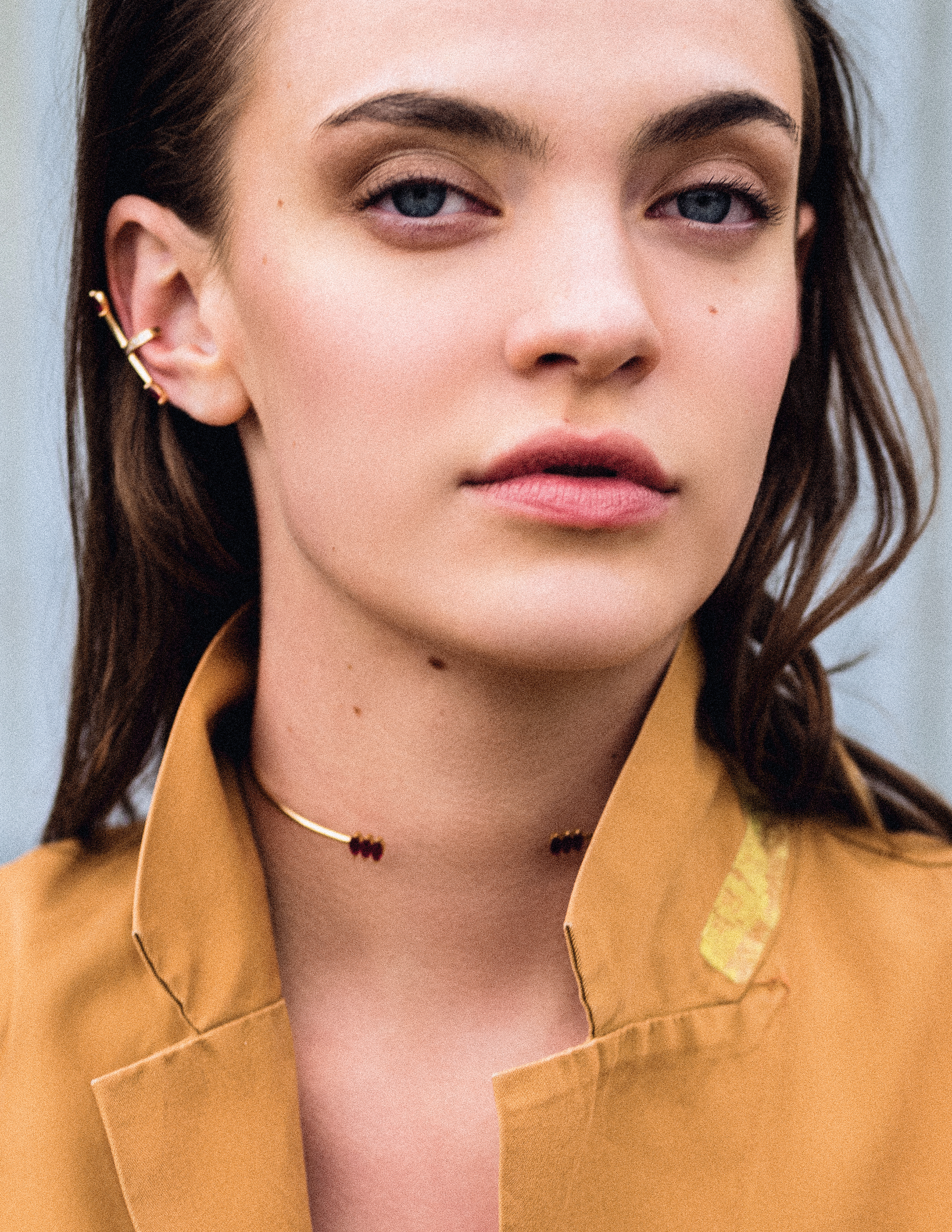 Close up shot of a girl wearing a simple gold necklace